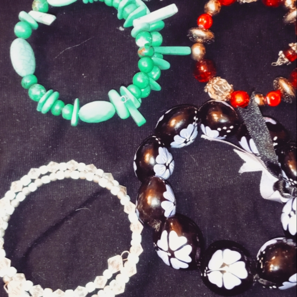 Handmade bracelets and a chunky purple stretchy bracelet.